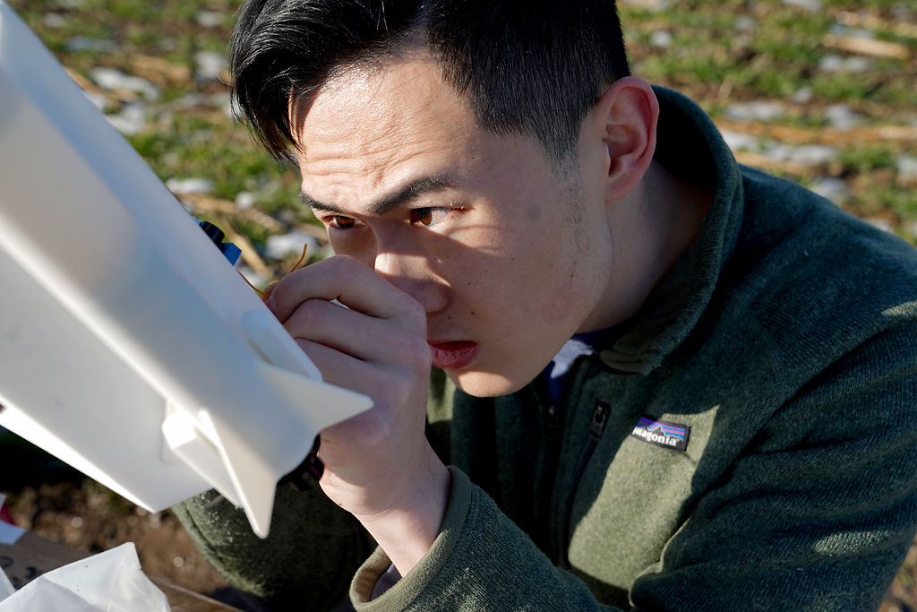 Edward Ge checks the connections on the rocket